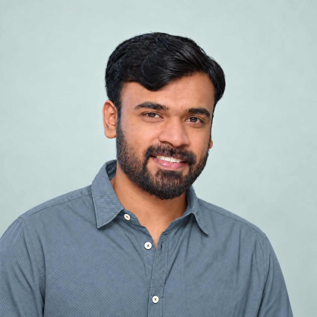 Portrait of Sreerag Sreenivasan against a soft neutral studio background